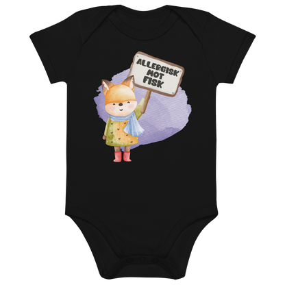 Svart babybody som ligger flatt, med en glad rev som holder oppe et skilt med teksten "Allergisk mot fisk". Foto.