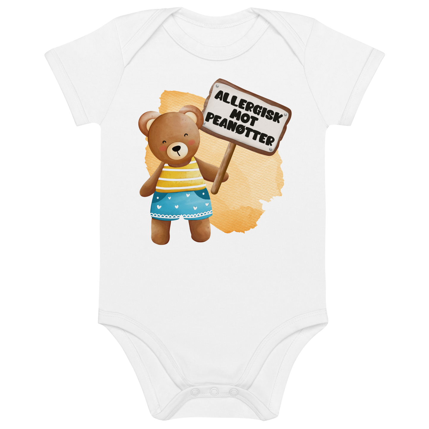 Hvit babybody som ligger flatt, med en glad bamse som holder oppe et skilt med teksten "Allergisk mot peanøtter". Foto.