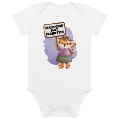 Hvit babybody som ligger flatt, med en glad tiger som holder oppe et skilt med teksten "Allergisk mot peanøtter". Foto.